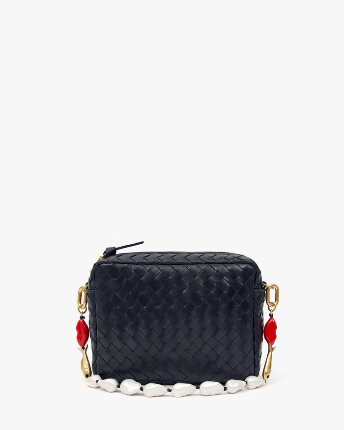 Clare V Shortie Strap in Multi Charm attached to a Midi Sac, detail of the wood and enamel charms