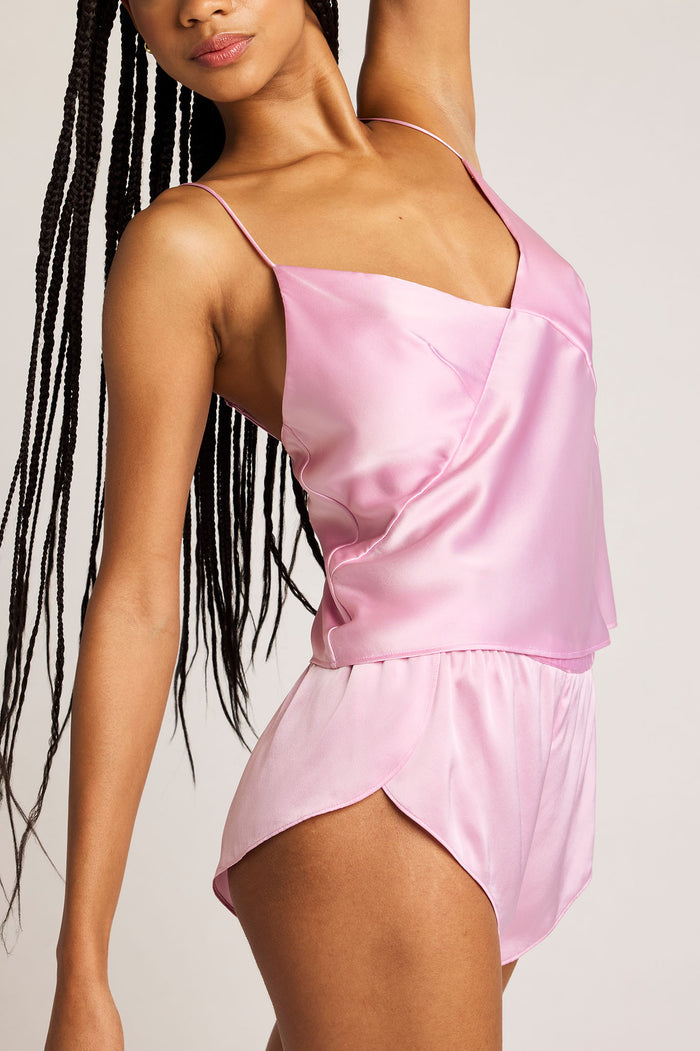Pink satin mini shorts with elastic waist, asymmetrical hem and crossover panel