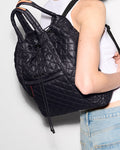 MZ Wallace Metro Convertible Backpack in black, worn on the shoulder by a model